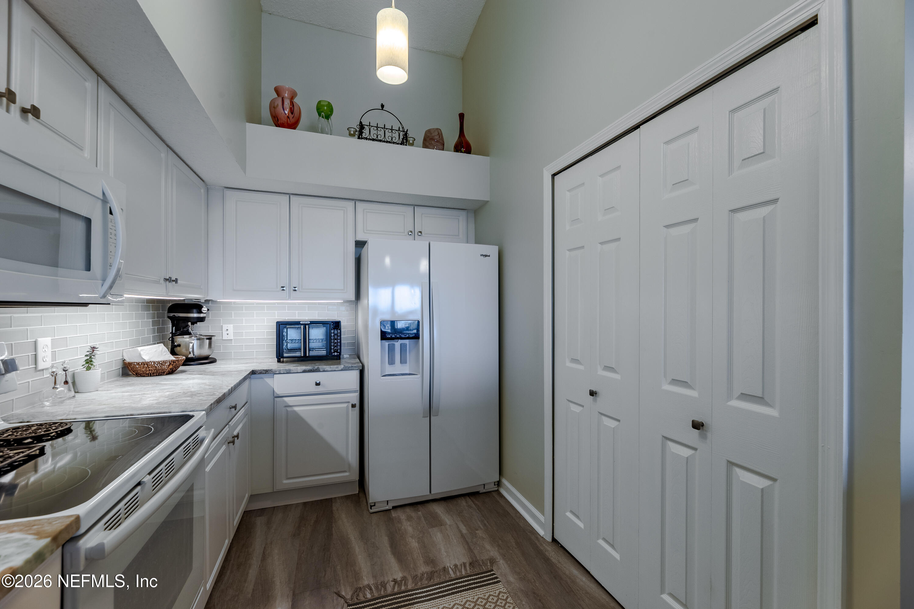 3327 Lighthouse Point Lane Jacksonville, FL 32250 - Photo 27 of 56 a kitchen with stainless steel appliances a refrigerator sink and cabinets