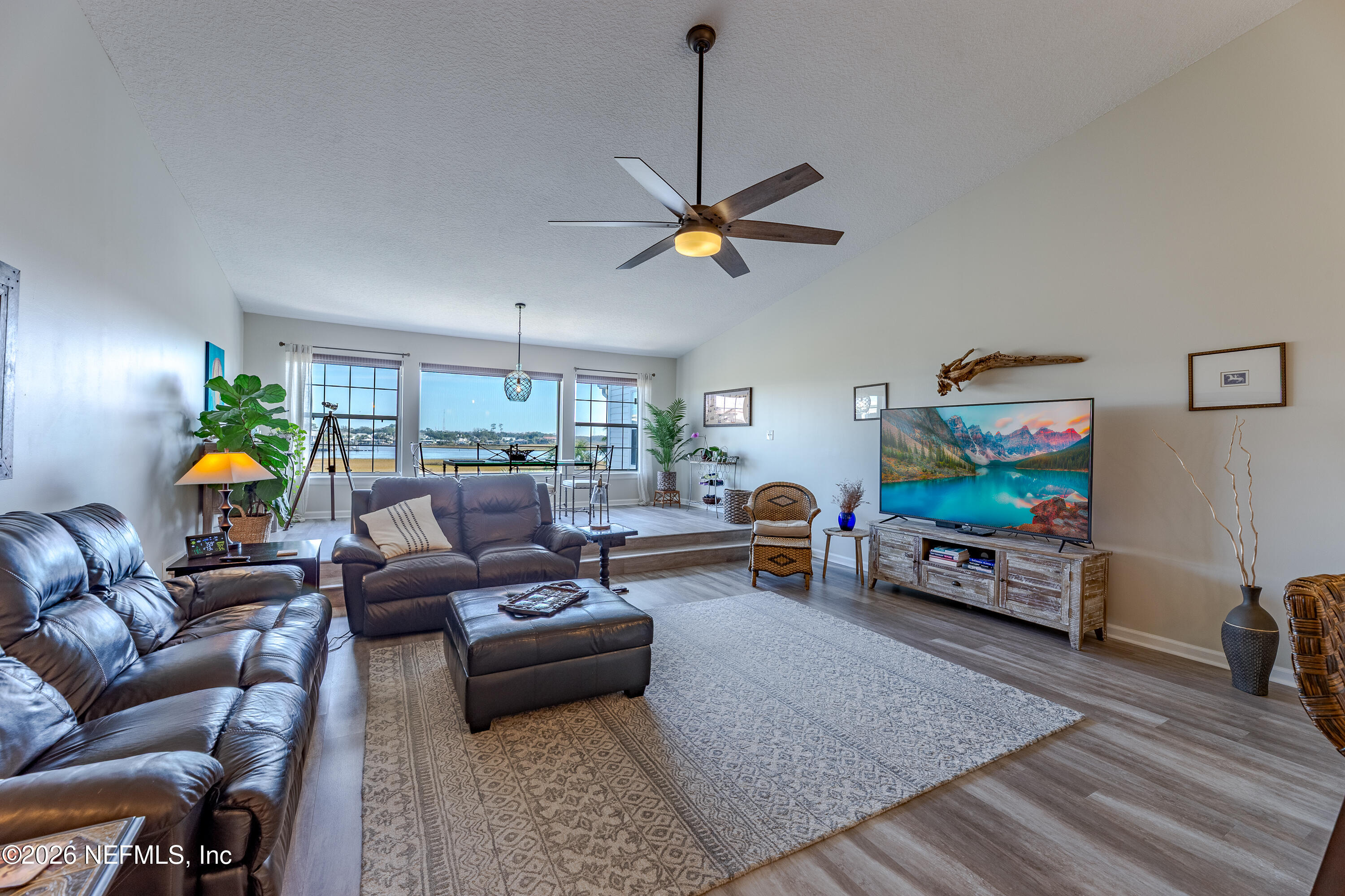 3327 Lighthouse Point Lane Jacksonville, FL 32250 - Photo 30 of 56 a living room with furniture and a flat screen tv
