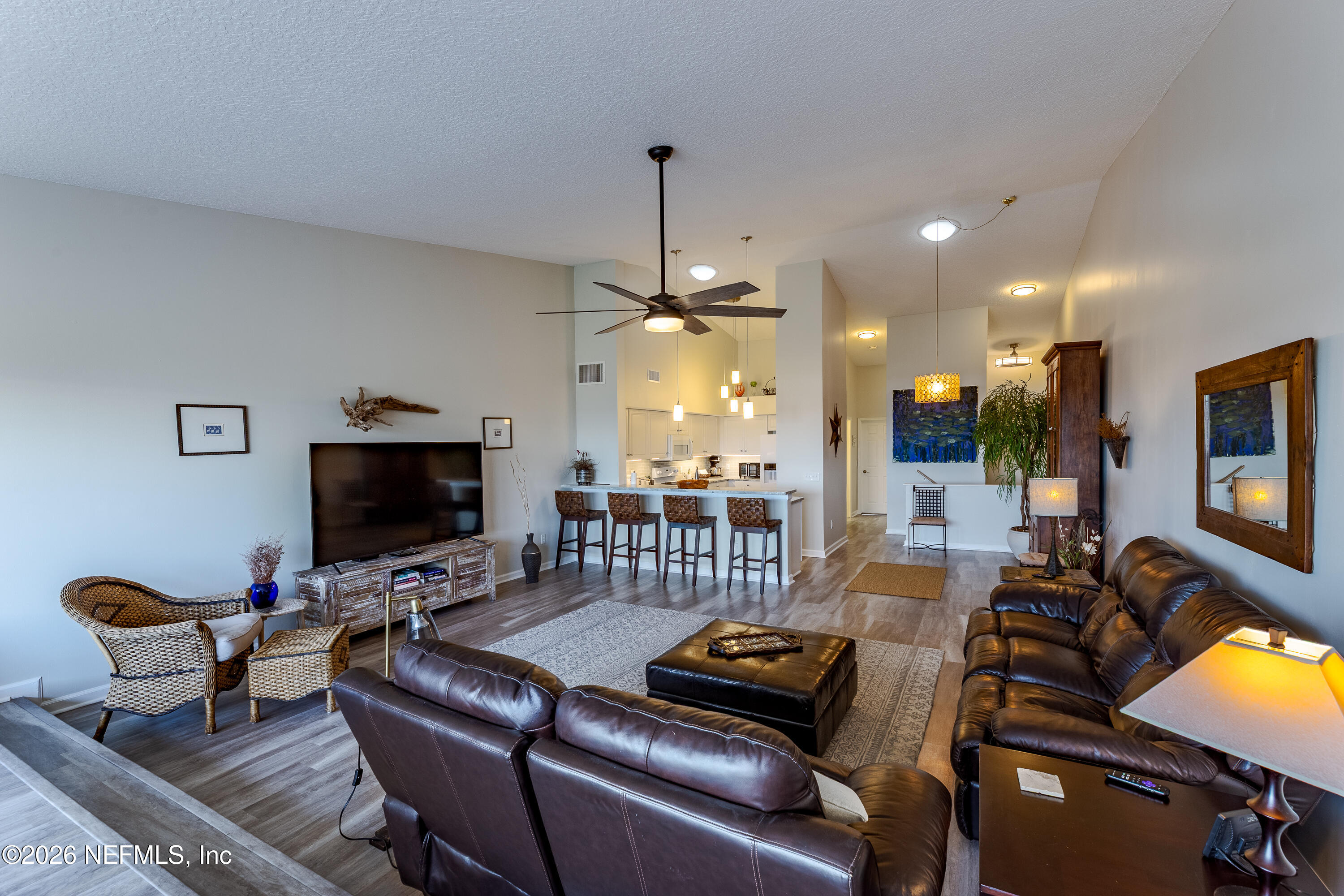 3327 Lighthouse Point Lane Jacksonville, FL 32250 - Photo 33 of 56 a living room with furniture a flat screen tv and kitchen view