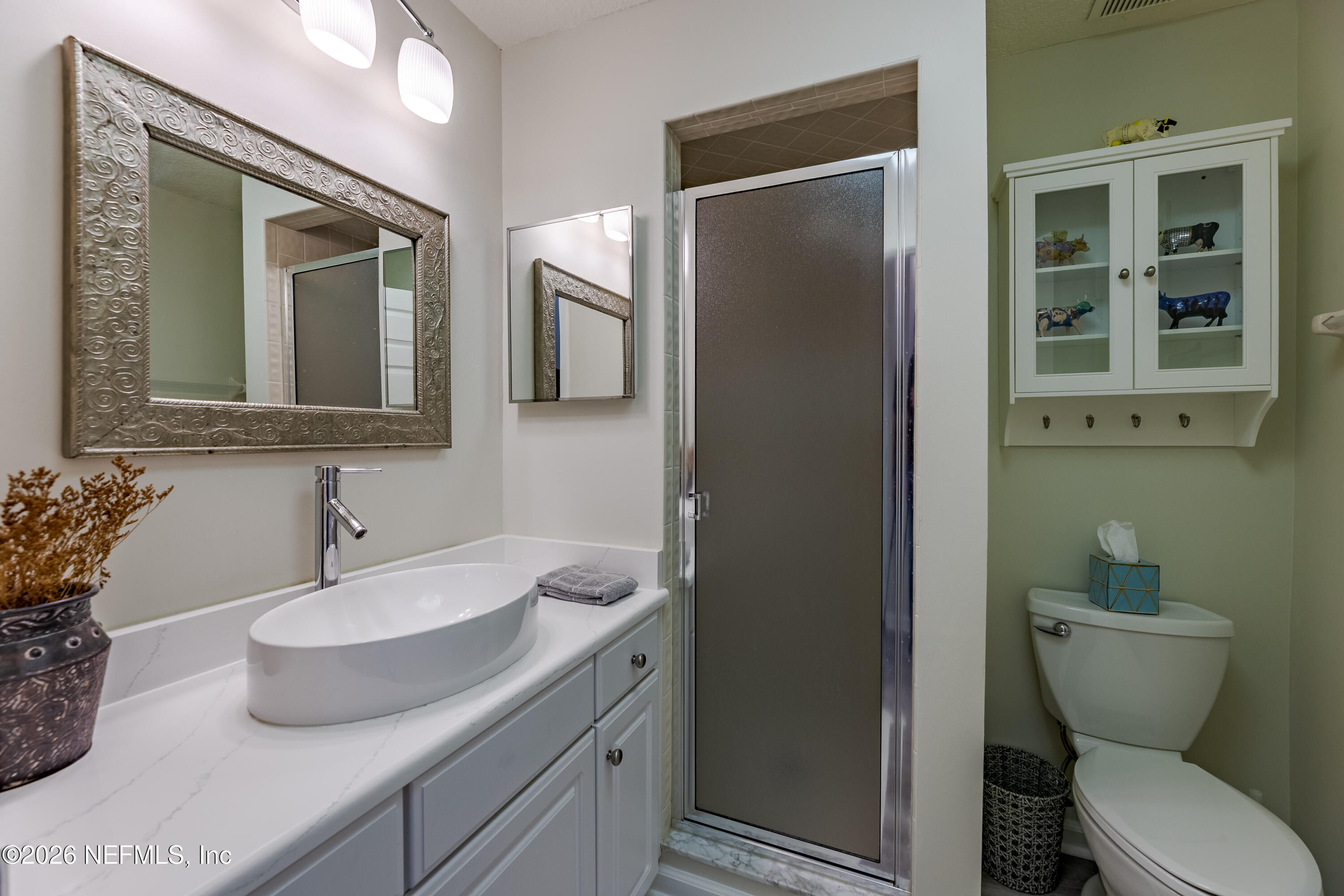 3327 Lighthouse Point Lane Jacksonville, FL 32250 - Photo 39 of 56 a bathroom with a toilet sink and mirror