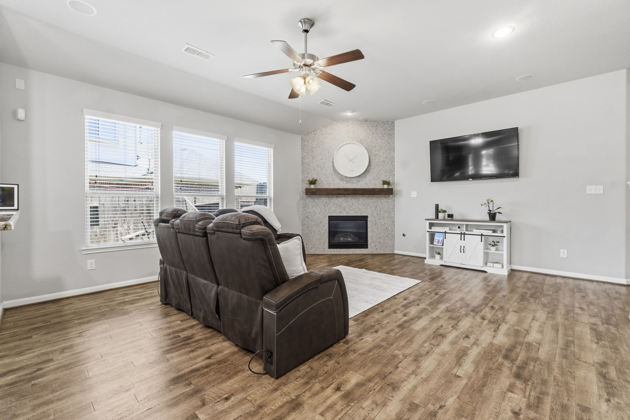 3900 Enchanted Timbers Lane Spring, TX 77386 - Photo 12 of 49 a living room with furniture a fireplace and a flat screen tv