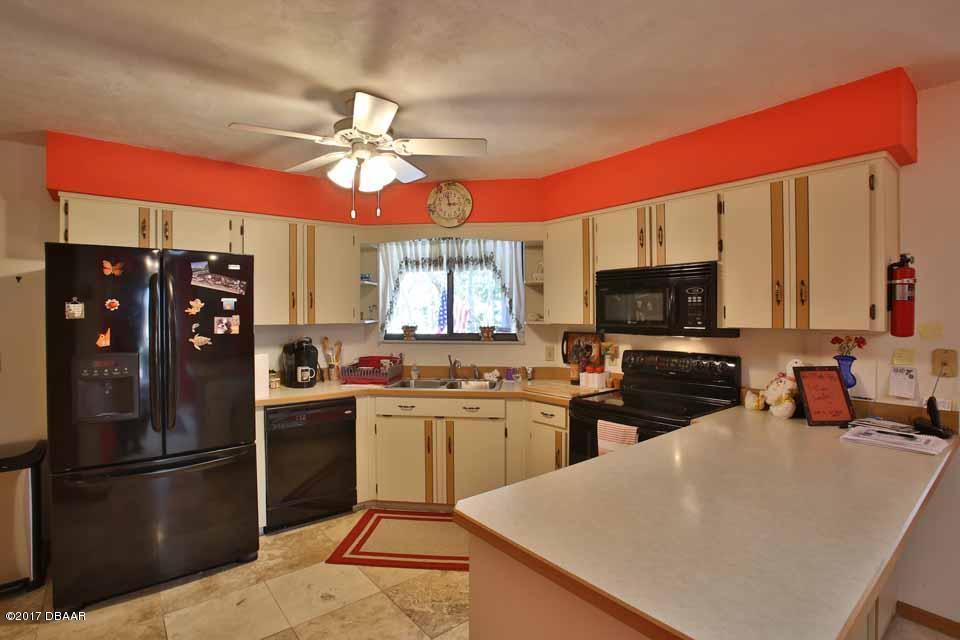 42 Crooked Pine Road Port Orange, FL 32128 - Photo 9 of 25 Kitchen w/travertine tile floors
