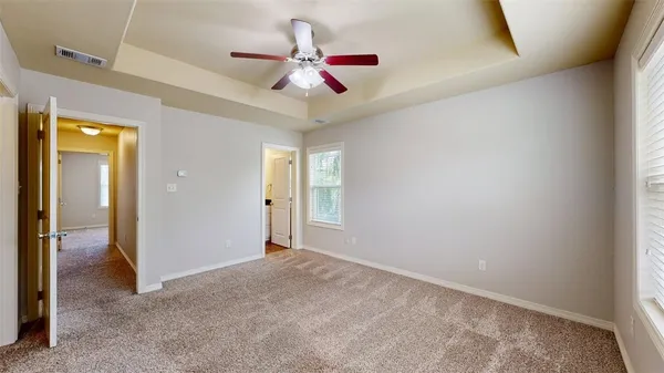a view of a livingroom with a ceiling fan and window