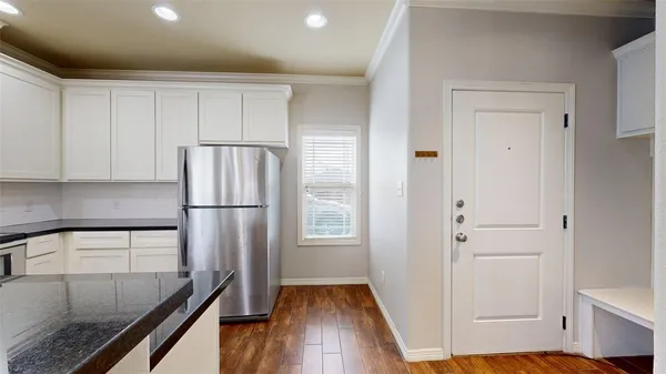 a kitchen with a refrigerator and a sink