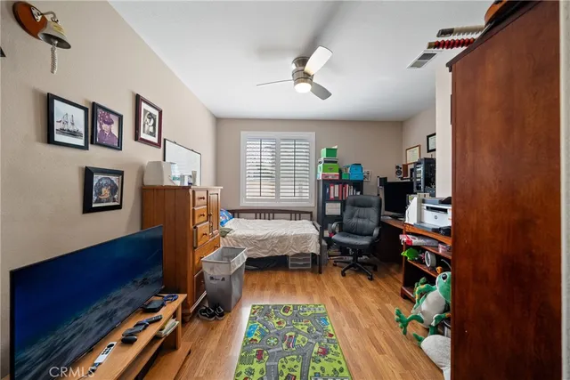 a bedroom with furniture and a wooden floor