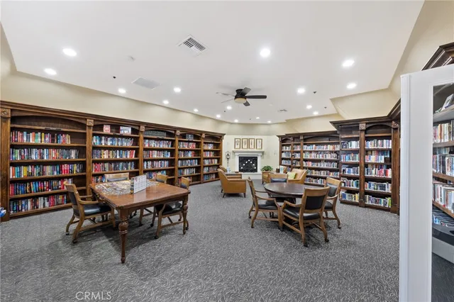 a view of a livingroom with furniture and a book shelf