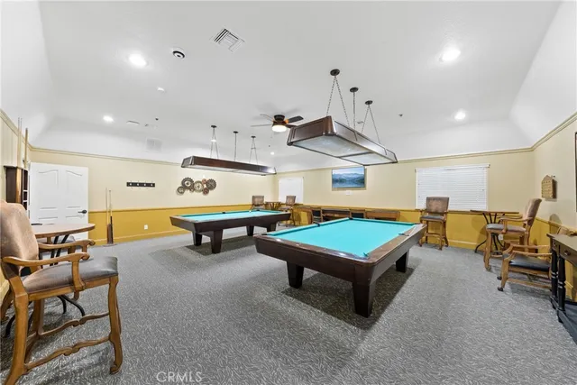 a room with furniture and pool tables