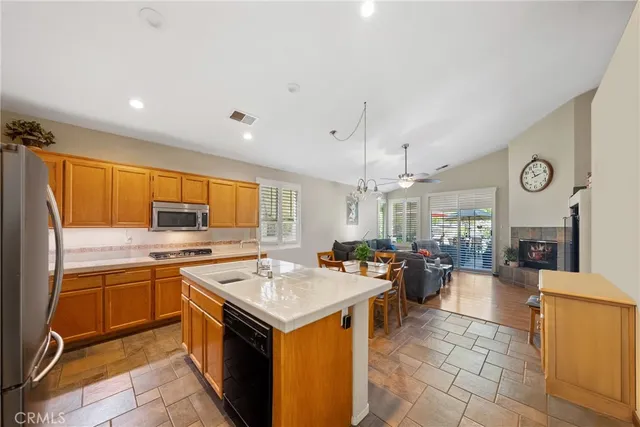 a kitchen with a sink counter top space and stainless steel appliances
