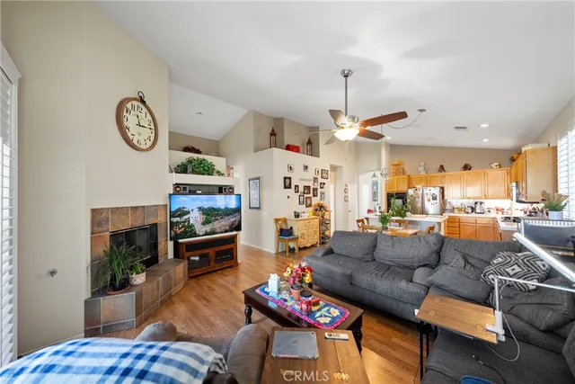 a living room with furniture a fireplace and a chandelier