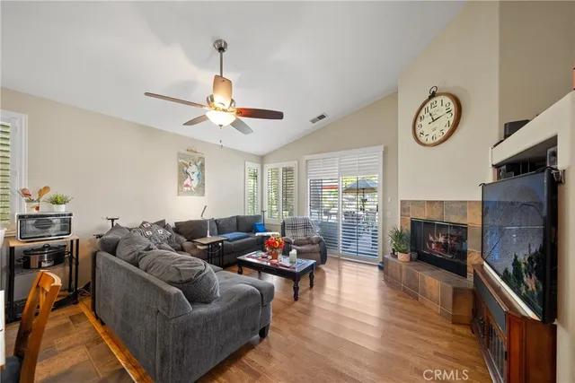 a living room with furniture a fireplace and a flat screen tv