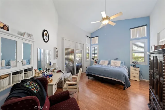 a bedroom with furniture and a large window