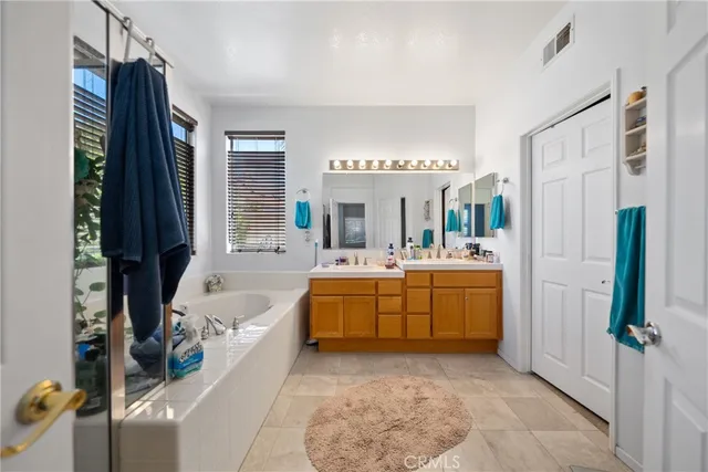 a bathroom with a tub sink and mirror