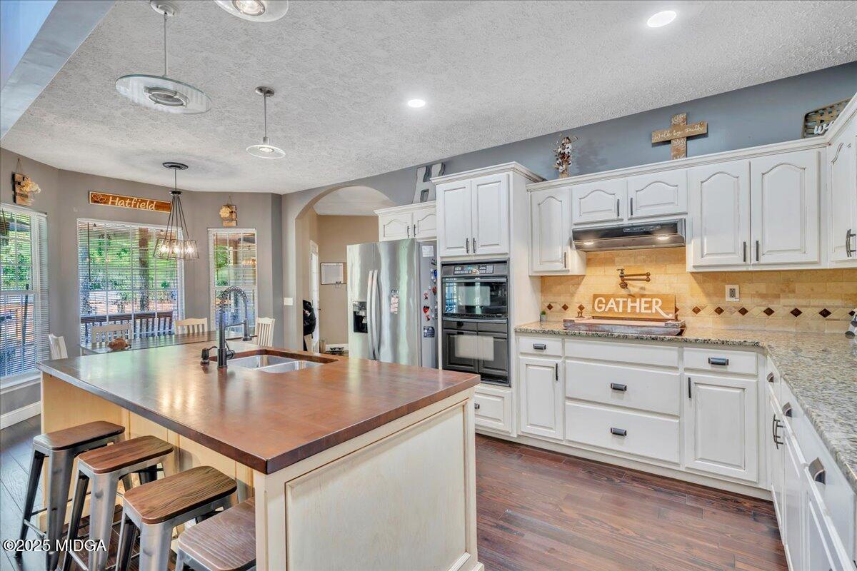 16 Little Collier Road Forsyth, GA 31029 - Photo 12 of 55 a kitchen with granite countertop a sink appliances cabinets and counter space