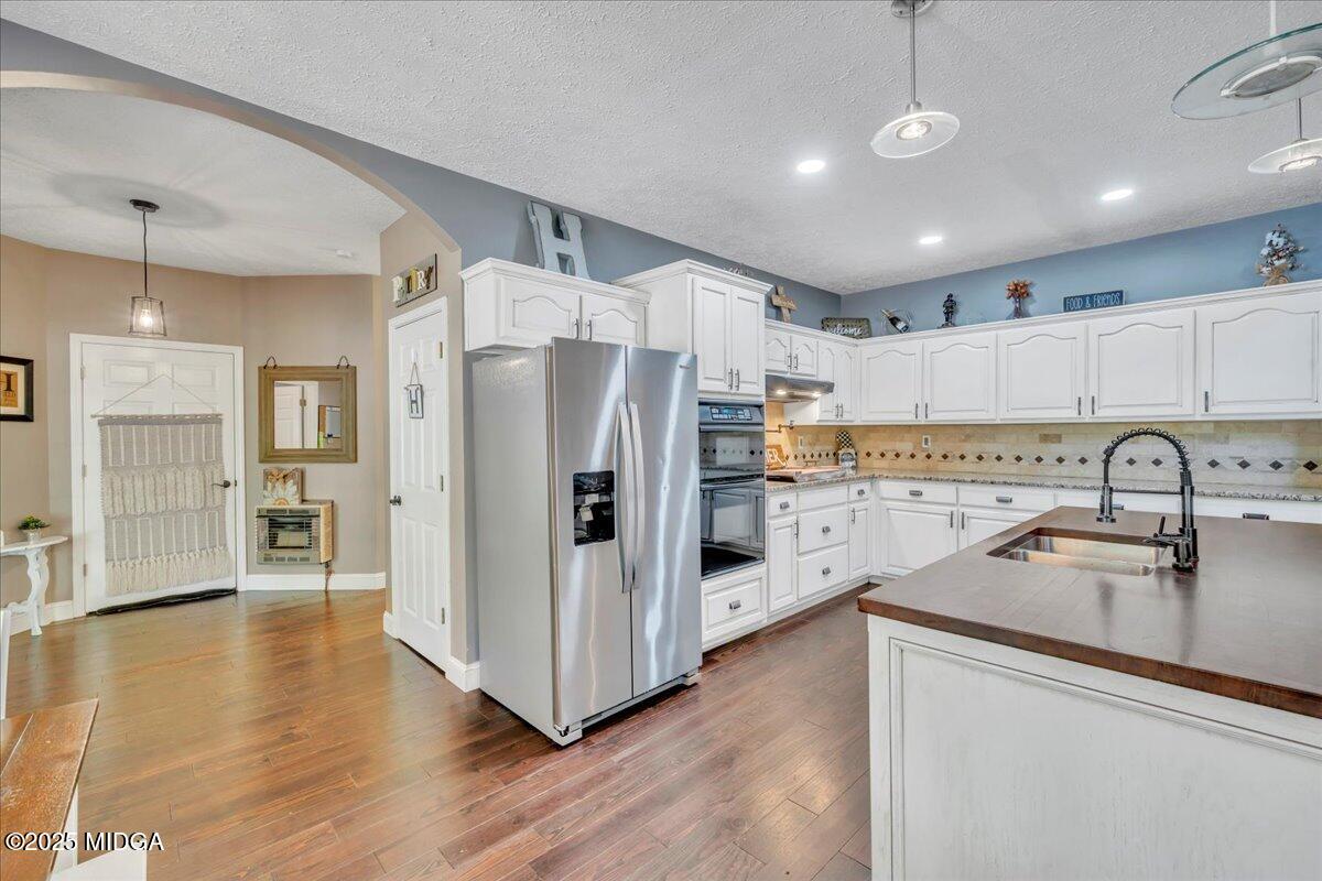 16 Little Collier Road Forsyth, GA 31029 - Photo 13 of 55 a kitchen with stainless steel appliances granite countertop a refrigerator sink and white cabinets