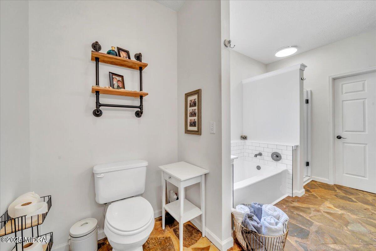 16 Little Collier Road Forsyth, GA 31029 - Photo 28 of 55 a bathroom with a toilet a sink and a shower