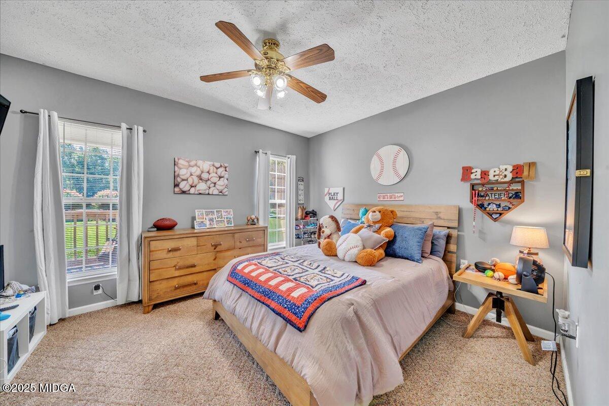 16 Little Collier Road Forsyth, GA 31029 - Photo 32 of 55 a bedroom with a bed and a chandelier