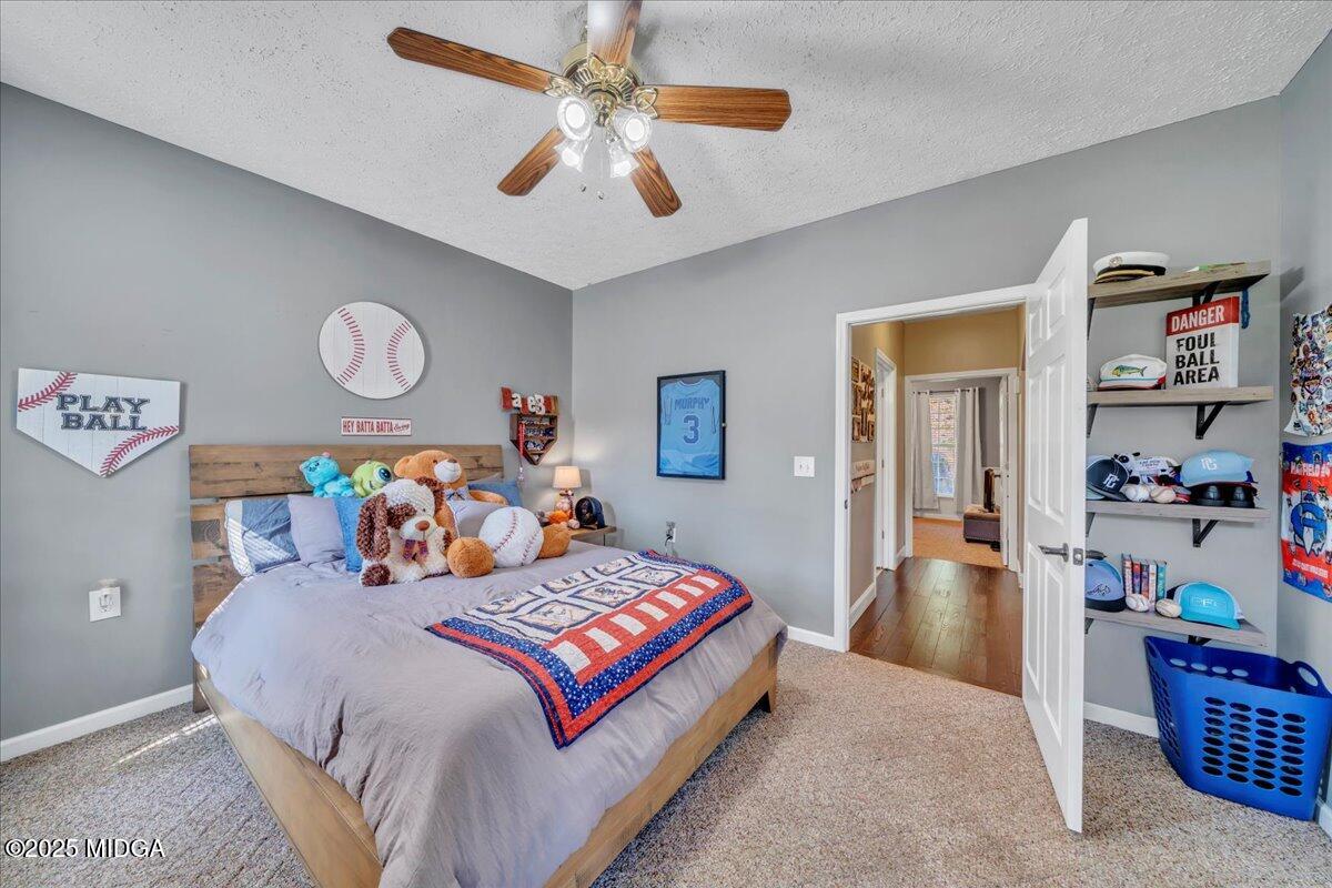 16 Little Collier Road Forsyth, GA 31029 - Photo 33 of 55 a bedroom with a bed and a chandelier