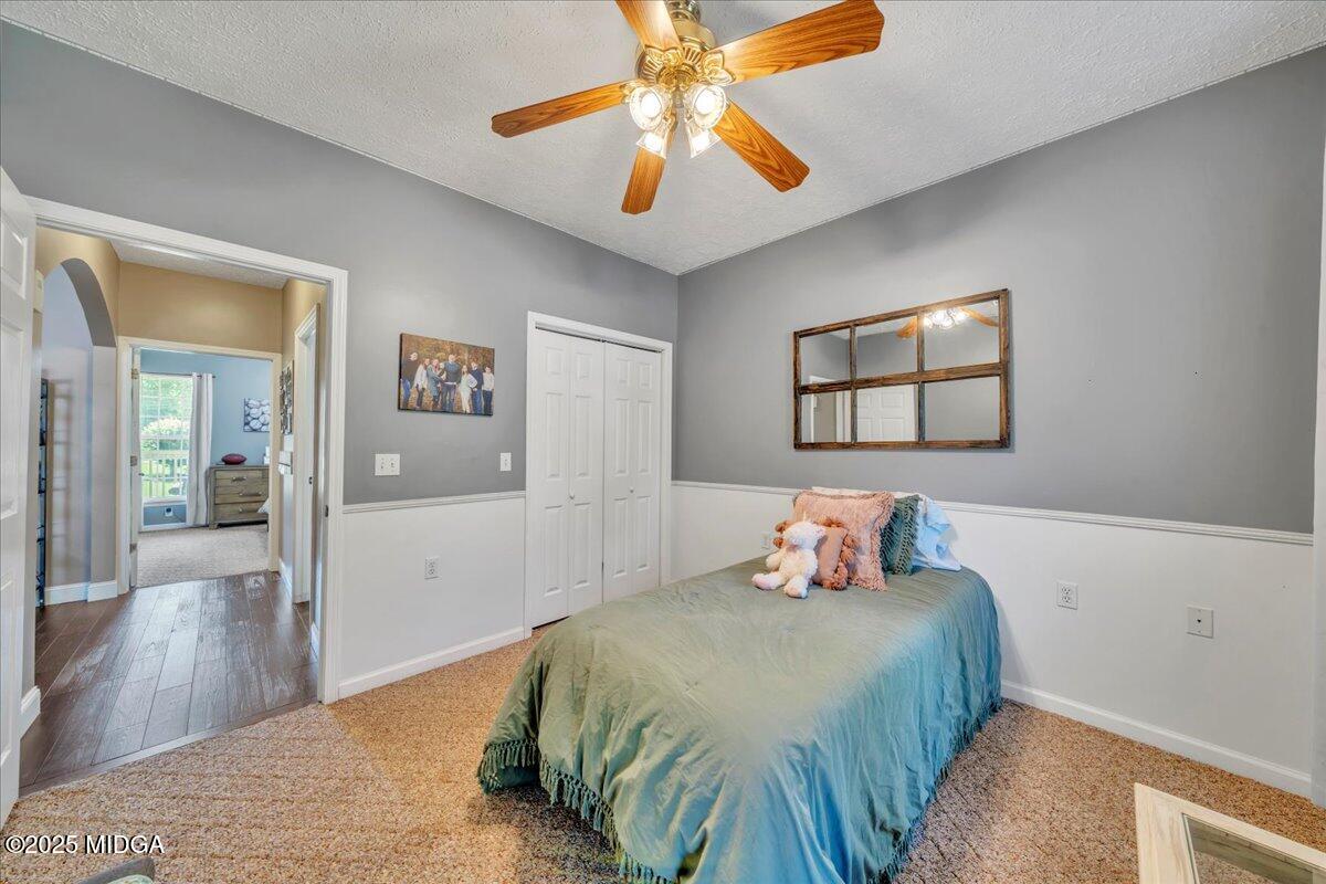16 Little Collier Road Forsyth, GA 31029 - Photo 35 of 55 a bedroom with a bed and a chandelier