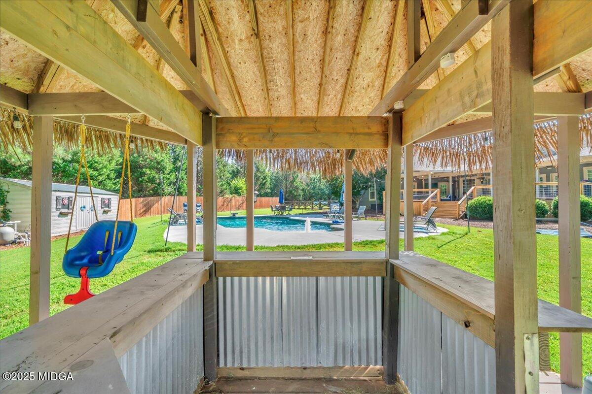16 Little Collier Road Forsyth, GA 31029 - Photo 43 of 55 a porch with a table and chairs next to a yard
