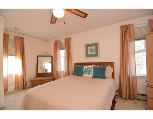 143 Overlook Road Arlington, MA 02474 - Photo 19 of 28 a bedroom with a large bed and a chandelier