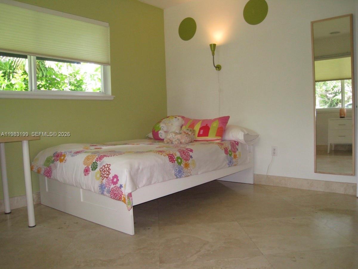 7440 Southwest 126th Street Pinecrest, FL 33156 - Photo 15 of 22 a bedroom with a bed and window