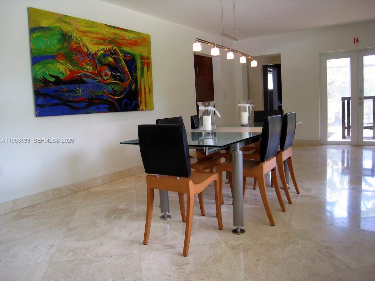 7440 Southwest 126th Street Pinecrest, FL 33156 - Photo 6 of 22 a view of a dining room with furniture and wooden floor