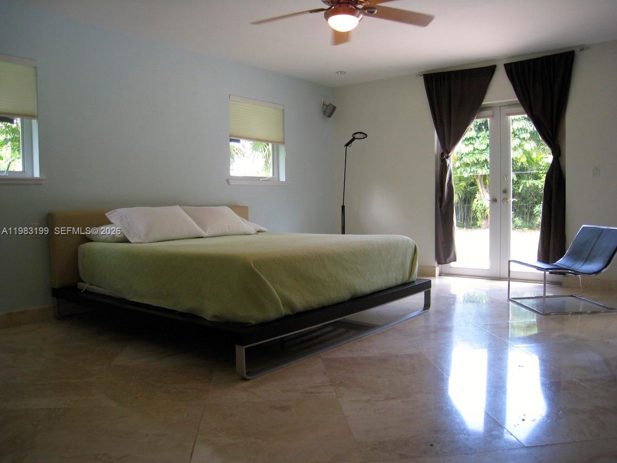 7440 Southwest 126th Street Pinecrest, FL 33156 - Photo 7 of 22 a bedroom with a bed and a large window