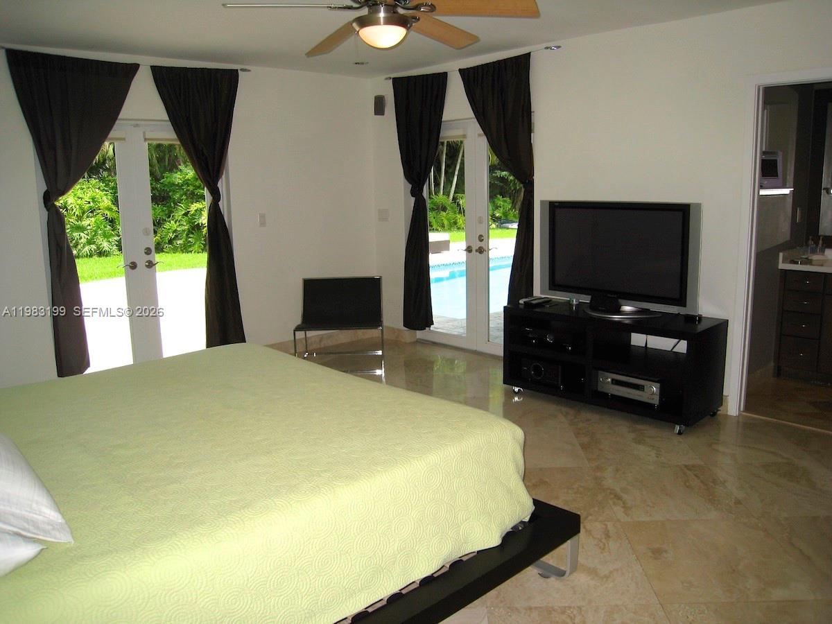 7440 Southwest 126th Street Pinecrest, FL 33156 - Photo 9 of 22 a bedroom with bed and window