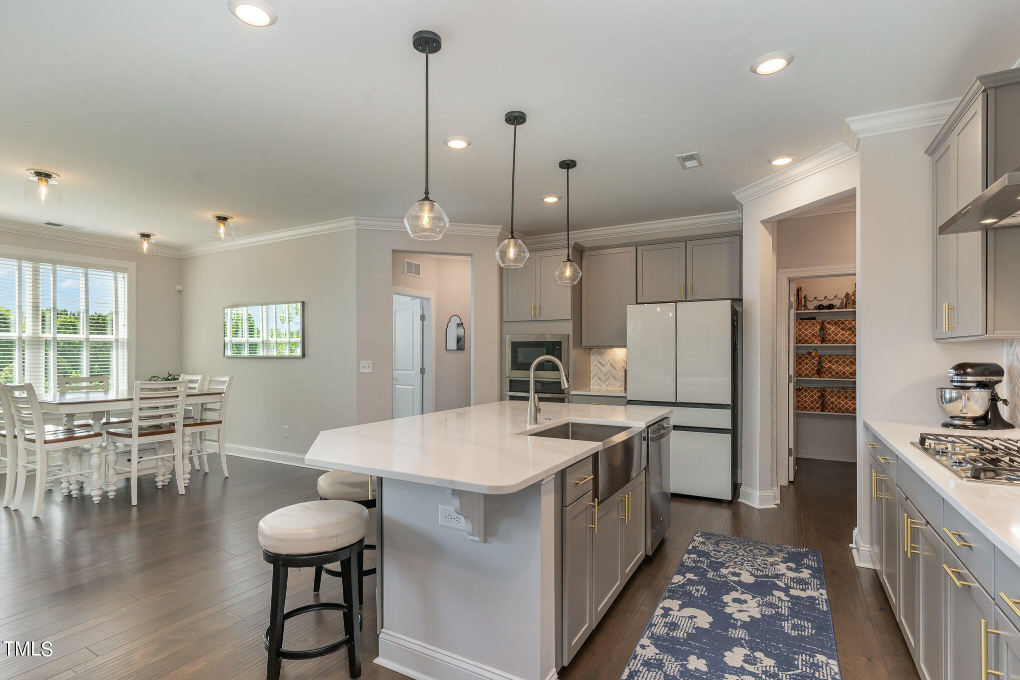 171 High Woods Ridge Pittsboro, NC 27312 - Photo 13 of 51 a kitchen with stainless steel appliances a dining table chairs stove refrigerator and cabinets