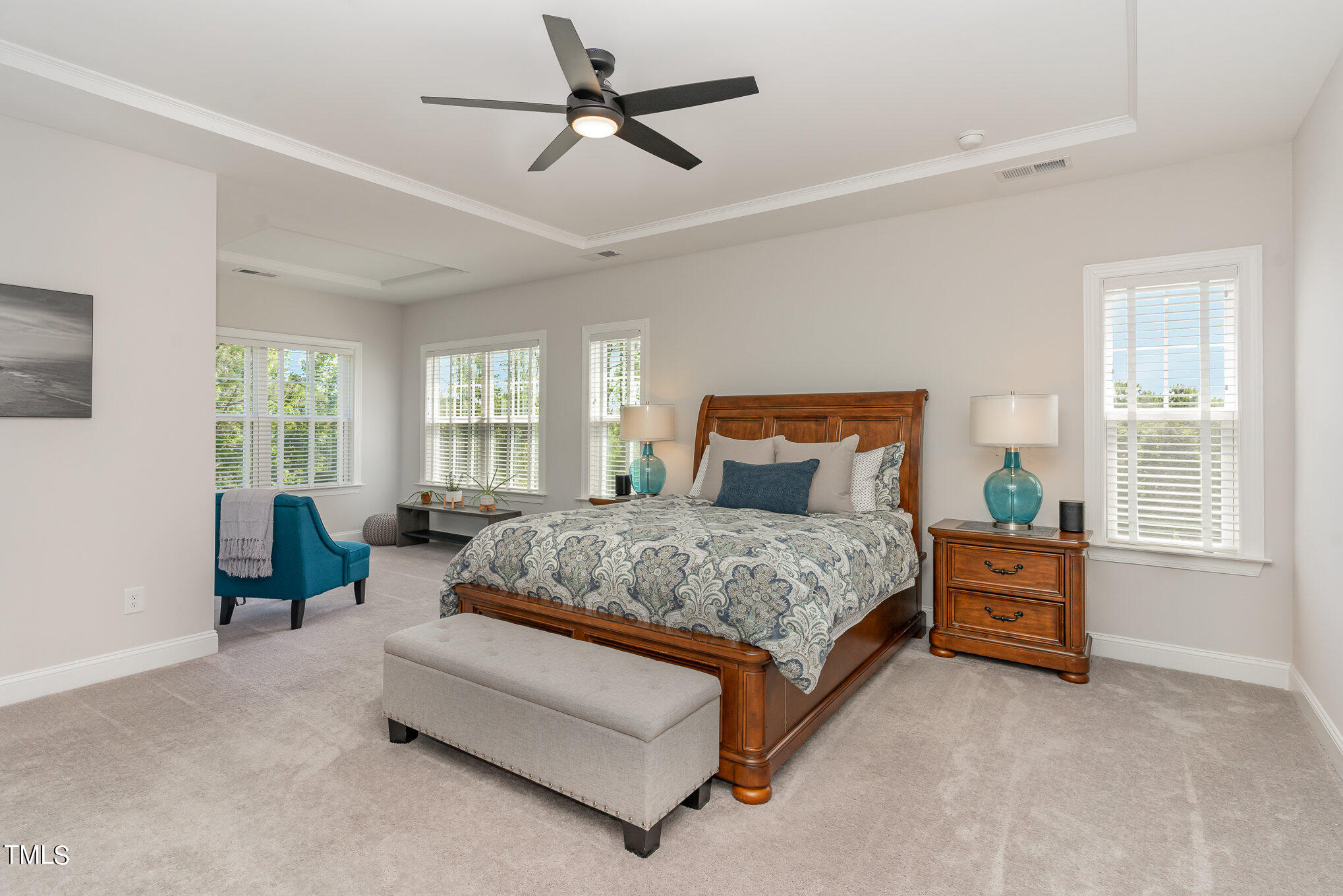 171 High Woods Ridge Pittsboro, NC 27312 - Photo 17 of 51 a spacious bedroom with a bed a couch and a window