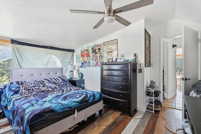 a bedroom with a bed and a chandelier