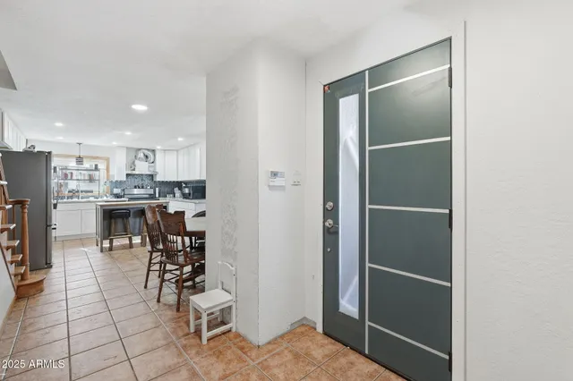 a view of kitchen with furniture and refrigerator