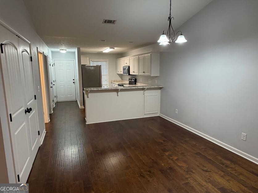 187 Buckhaven Way Statesboro, GA 30458 - Photo 16 of 20 a kitchen with a refrigerator a sink and a wooden floor