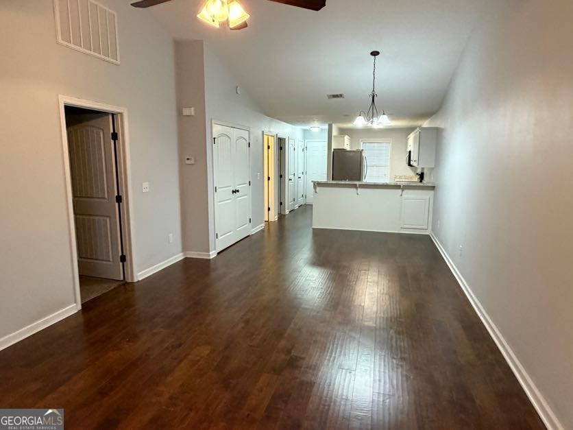 187 Buckhaven Way Statesboro, GA 30458 - Photo 19 of 20 an empty room with wooden floor chandelier and windows