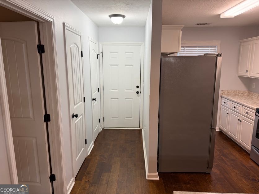 187 Buckhaven Way Statesboro, GA 30458 - Photo 3 of 20 a view of hallway with stainless steel appliances wooden floor and staircase