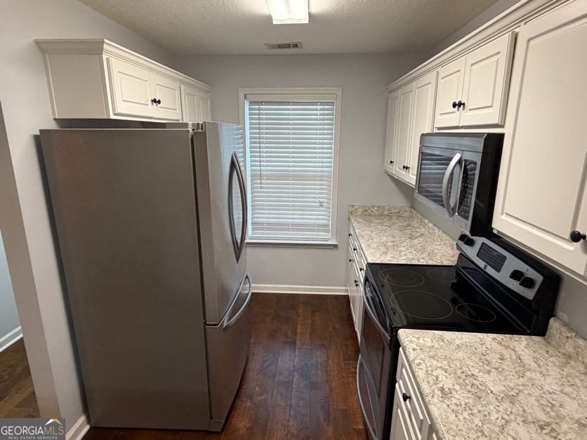 187 Buckhaven Way Statesboro, GA 30458 - Photo 6 of 20 a kitchen with a refrigerator stove and wooden cabinets