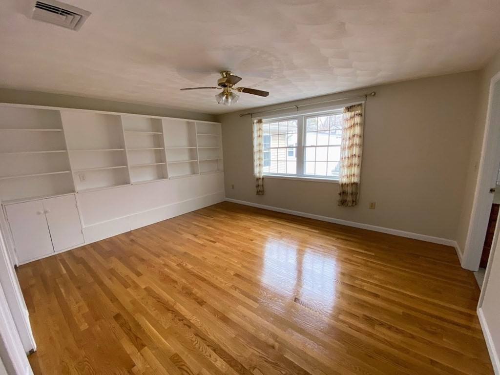 390 Marrett Road Lexington, MA 02421 - Photo 11 of 11 a view of empty room with wooden floor and fan