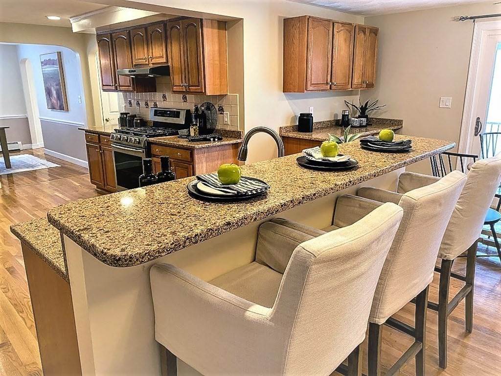 390 Marrett Road Lexington, MA 02421 - Photo 2 of 11 a kitchen with granite countertop lots of counter top space and stainless steel appliances
