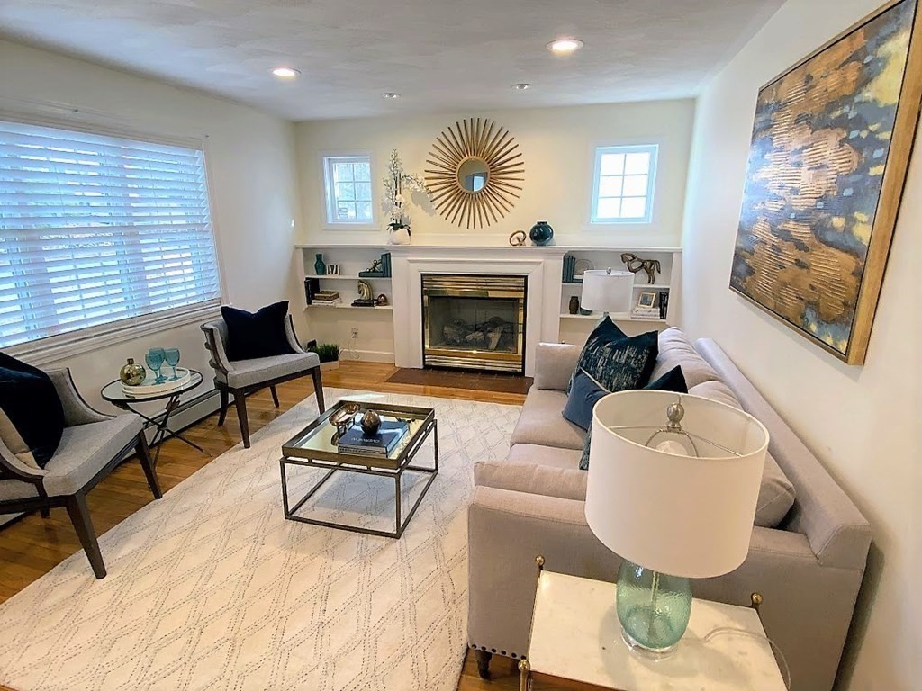 390 Marrett Road Lexington, MA 02421 - Photo 3 of 11 a living room with furniture and a fireplace