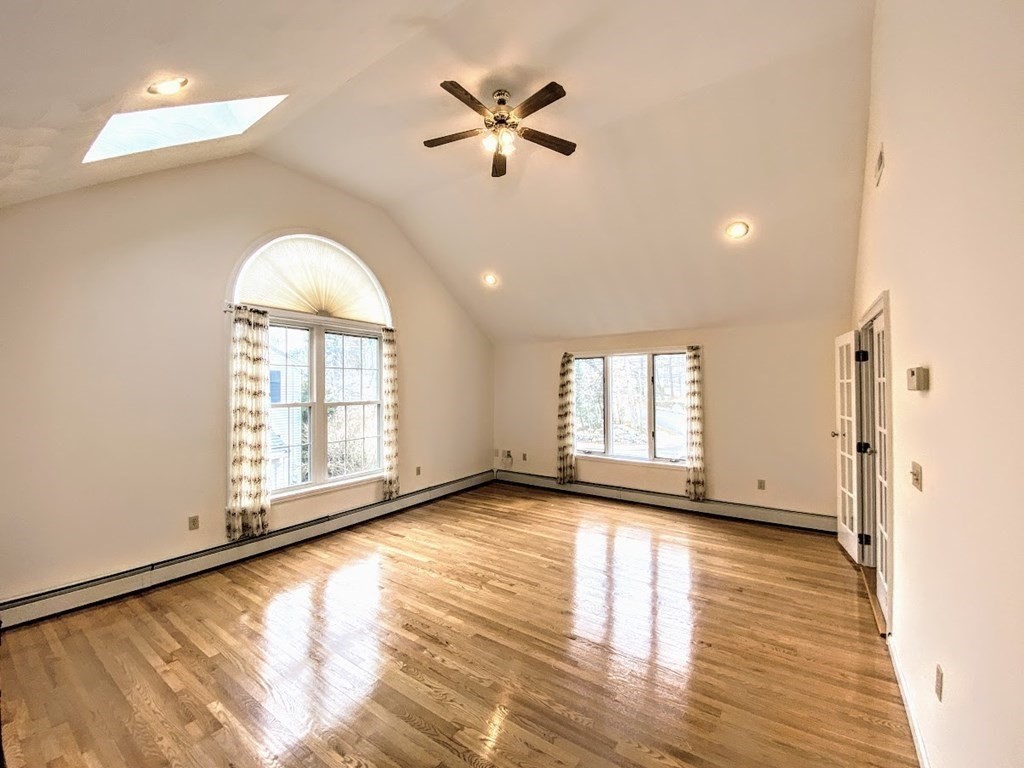 390 Marrett Road Lexington, MA 02421 - Photo 4 of 11 an empty room with wooden floor and windows