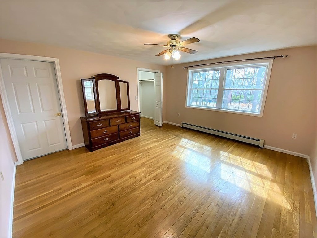 390 Marrett Road Lexington, MA 02421 - Photo 6 of 11 a view of an empty room with a window and wooden floor