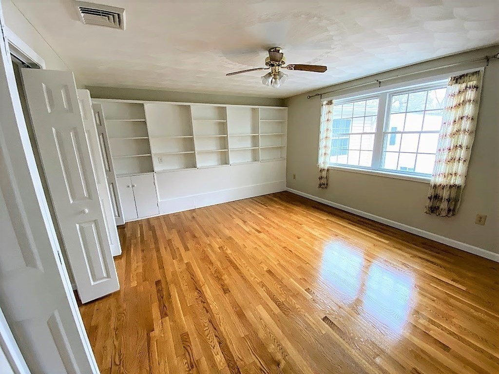 390 Marrett Road Lexington, MA 02421 - Photo 7 of 11 a view of an empty room with wooden floor and a window