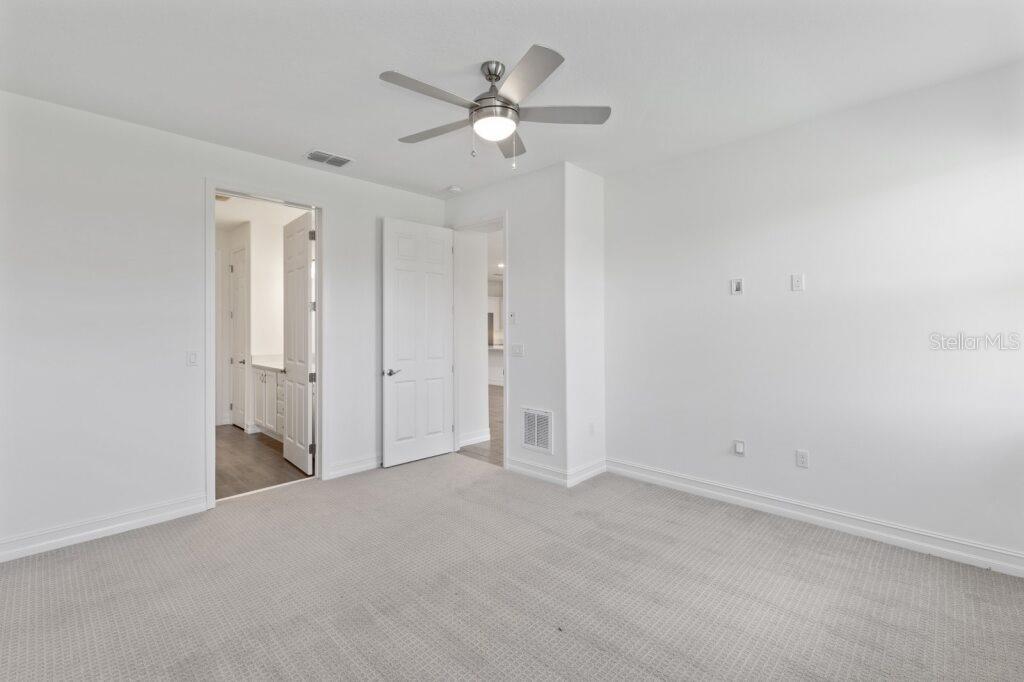 3223 Northwest 52nd Avenue Road Ocala, FL 34482 - Photo 17 of 25 an empty room with closet and a ceiling fan