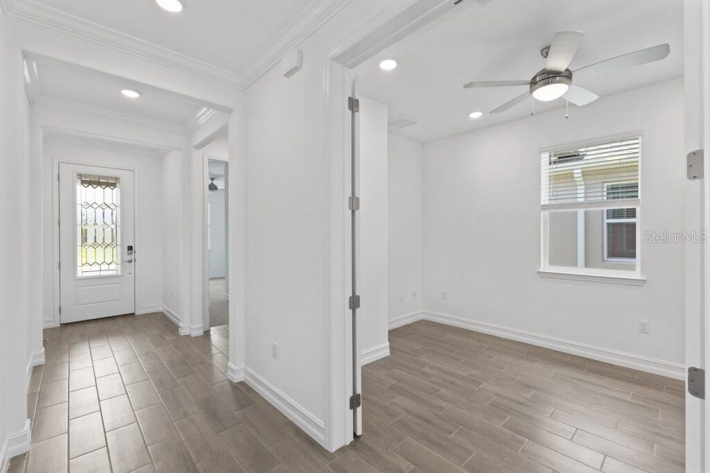 3223 Northwest 52nd Avenue Road Ocala, FL 34482 - Photo 2 of 25 an empty room with wooden floor and windows
