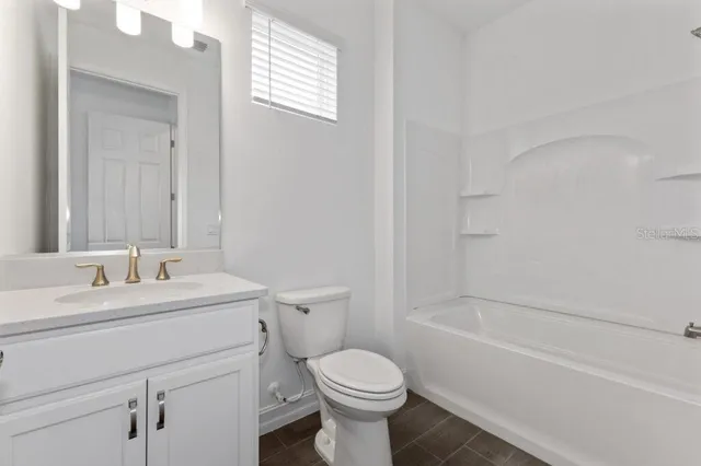 a bathroom with a sink toilet vanity and shower