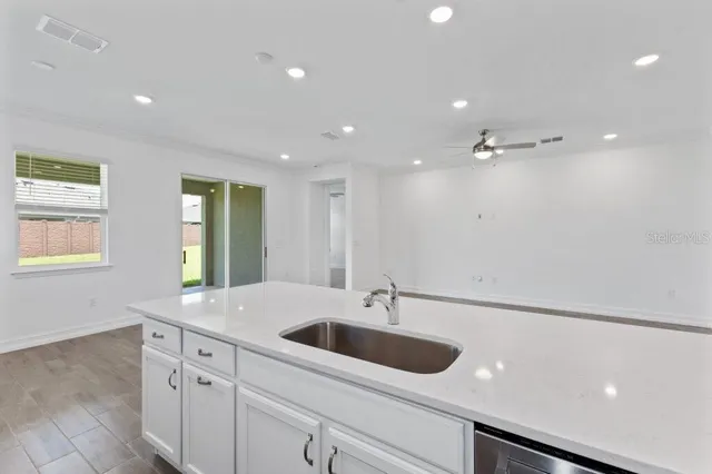 a view of a kitchen sink a window and stainless steel appliances