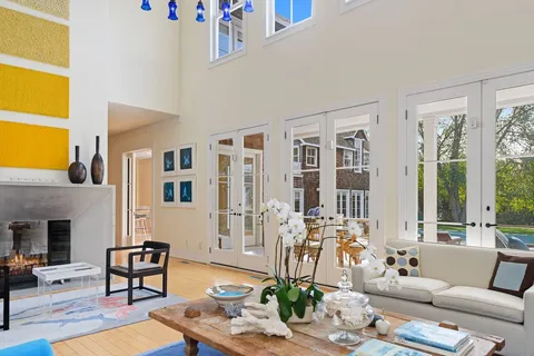a living room with furniture and a floor to ceiling window
