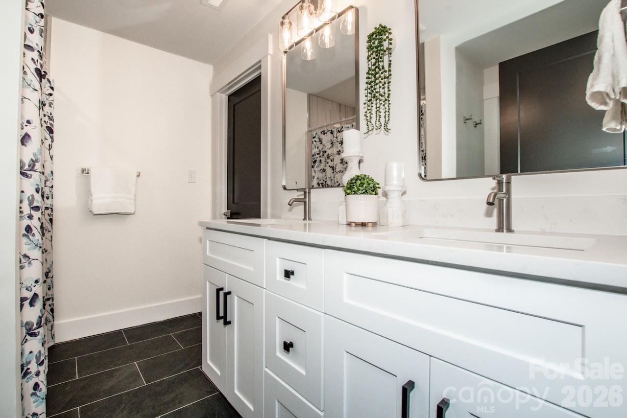 6229 Mountain Grove Road Hickory, NC 28602 - Photo 20 of 41 a bathroom with double vanity sink and mirror