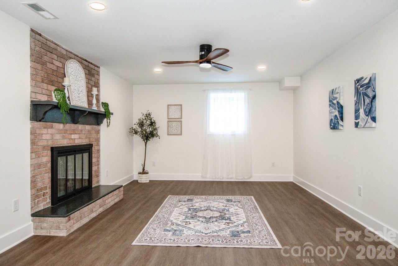 6229 Mountain Grove Road Hickory, NC 28602 - Photo 24 of 41 a view of a livingroom with a fireplace a chandelier and wooden floor