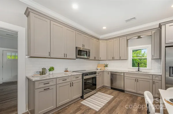 a kitchen with a sink window and cabinets